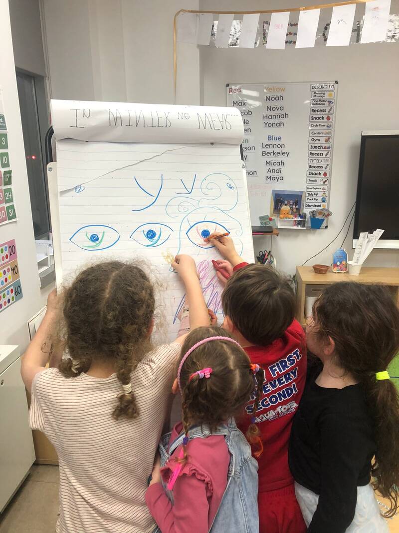 A City Shul School teacher leading a small group of students